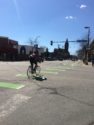 Man on bicycle without helmet crossing street at intersection in Whittier, neighborhood in Minneapolis, Minnesota, USA