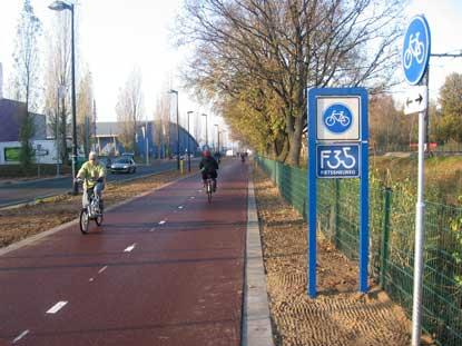 Cycle highway alongside larger road in the Netherlands.