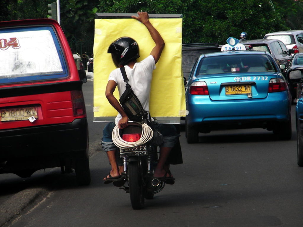 Motorcycles are used as taxis in Indonesia.