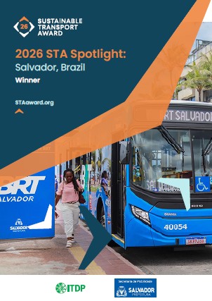 Poster announcing 2026 STA Spotlight winner, Salvador, Brazil; shows a blue city bus at a Salvador bus stop with logos for Sustainable Transport Award and ITDP.
