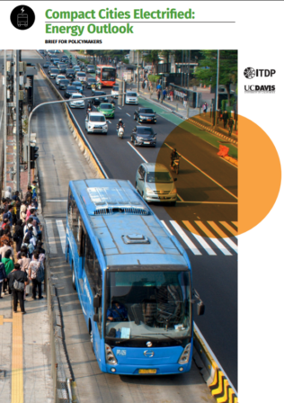 Busy urban street with a blue bus, cars, and pedestrians, illustrating a policy brief on electrified compact cities.