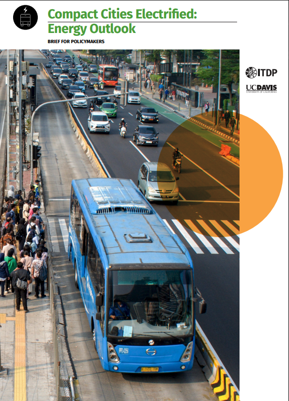 Busy urban street with a blue bus, cars, and pedestrians, illustrating a policy brief on electrified compact cities.