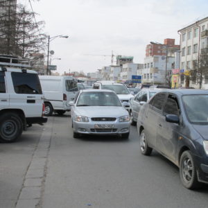 Van moving out of parking space into traffic jam_UB_April2011_MK