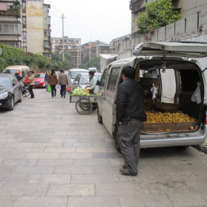 Produce truck in courtyard area with lots of other parking_Kunming_March2011